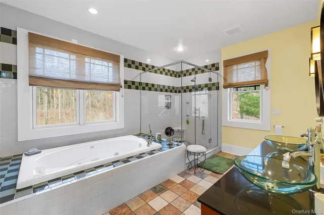 a spacious bathroom with a tub and large window