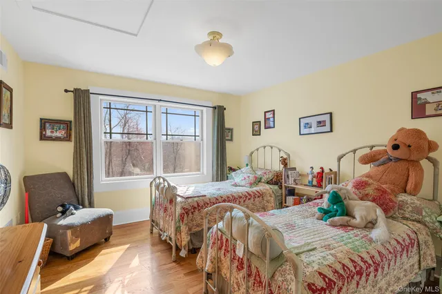a bedroom with two beds and a large window