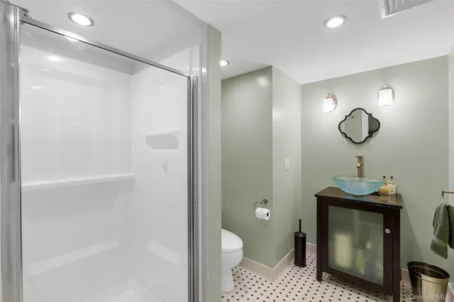 a bathroom with a toilet a sink and shower