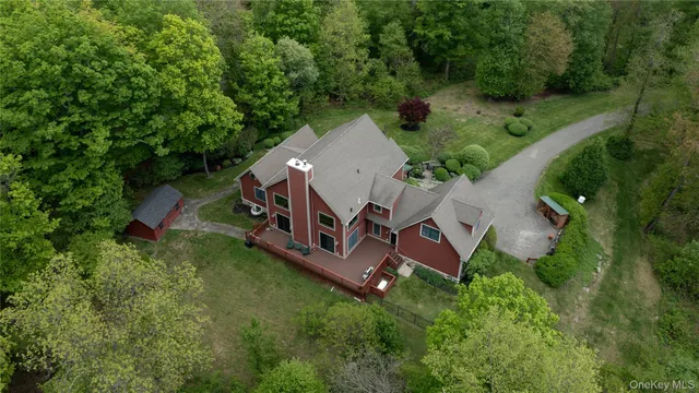 an aerial view of a house with outdoor space pool seating area and yard