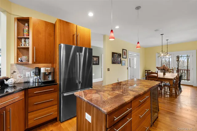 a kitchen with stainless steel appliances granite countertop a sink refrigerator and cabinets