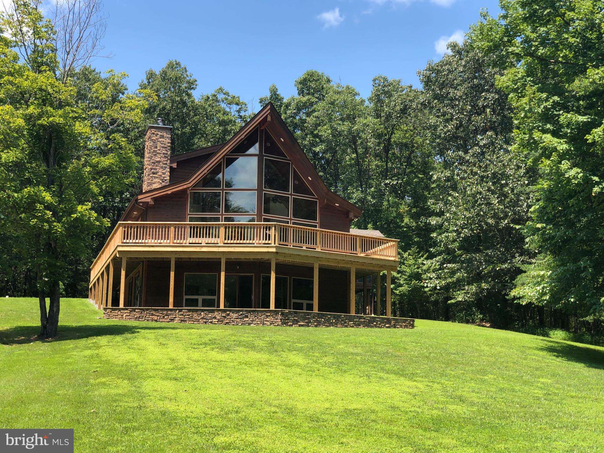 1352 Virginia Line-Potomac Road Berkeley Springs, WV 25411 - Photo 1 of 32 a front view of a house with a garden