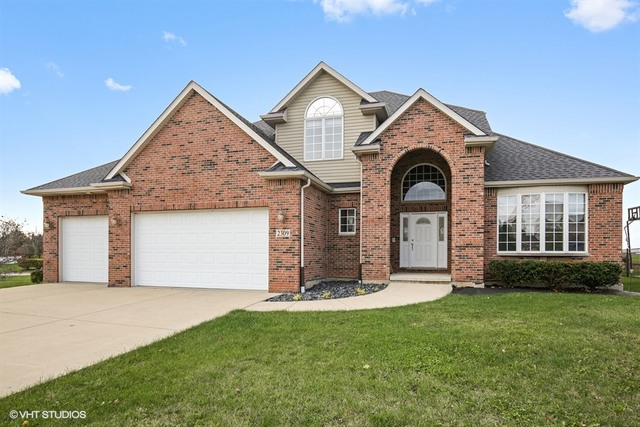 2309 Dean Street Sycamore, IL 60178 - Photo 1 of 25 a front view of a house with a yard and garage