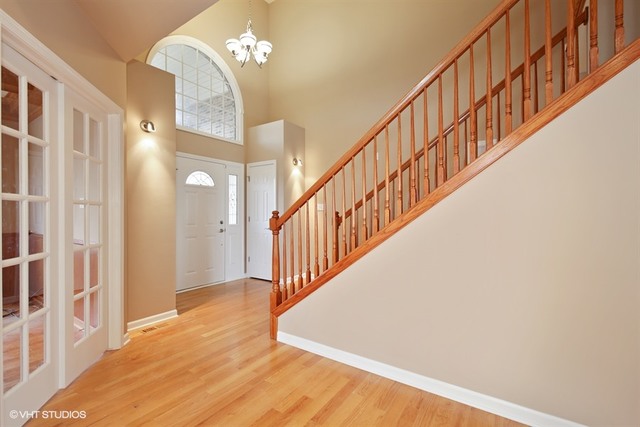 2309 Dean Street Sycamore, IL 60178 - Photo 2 of 25 a view of staircase with railing and a chandelier