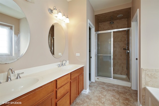 2309 Dean Street Sycamore, IL 60178 - Photo 13 of 25 a bathroom with a double vanity sink mirror and shower