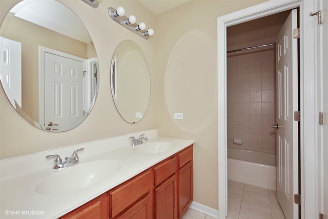 2309 Dean Street Sycamore, IL 60178 - Photo 17 of 25 a bathroom with a double vanity sink mirror and bathtub