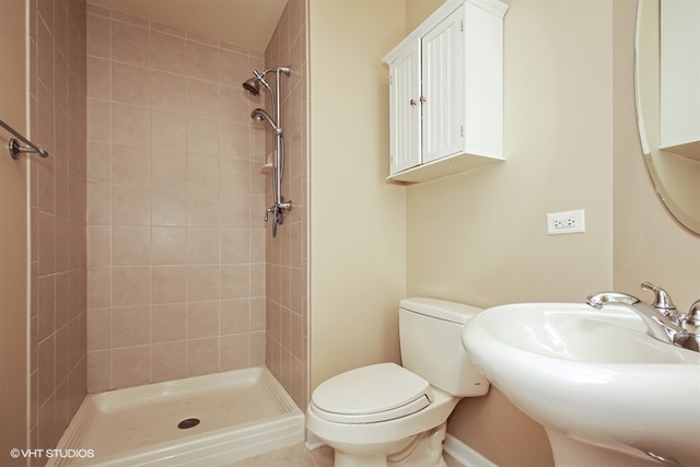 2309 Dean Street Sycamore, IL 60178 - Photo 20 of 25 a bathroom with a shower a toilet and a sink