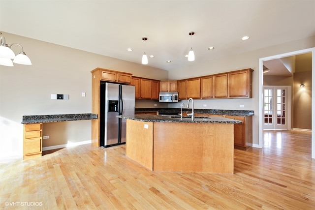 2309 Dean Street Sycamore, IL 60178 - Photo 3 of 25 a kitchen with stainless steel appliances granite countertop a refrigerator and a stove top oven