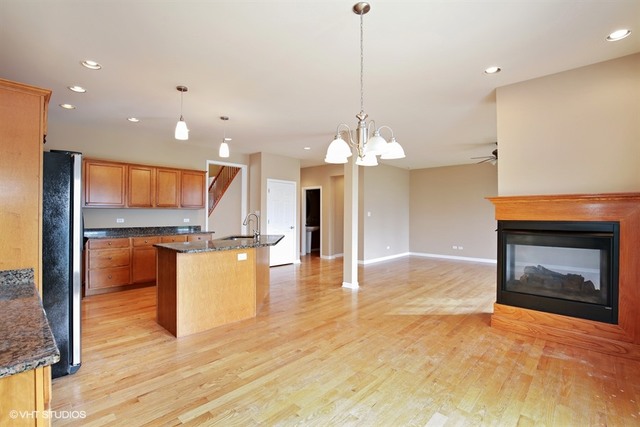 2309 Dean Street Sycamore, IL 60178 - Photo 4 of 25 a view of a kitchen with a sink and a fireplace