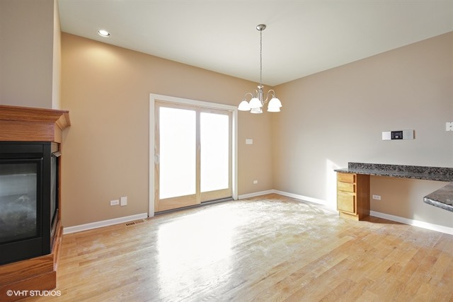 2309 Dean Street Sycamore, IL 60178 - Photo 6 of 25 a view of an empty room with a fireplace and a window