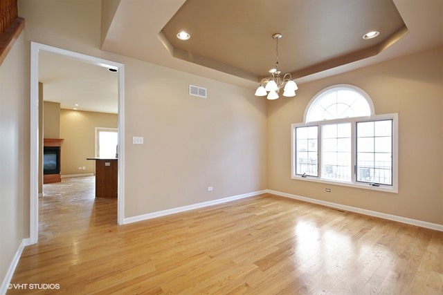 2309 Dean Street Sycamore, IL 60178 - Photo 7 of 25 wooden floor in an empty room with a window