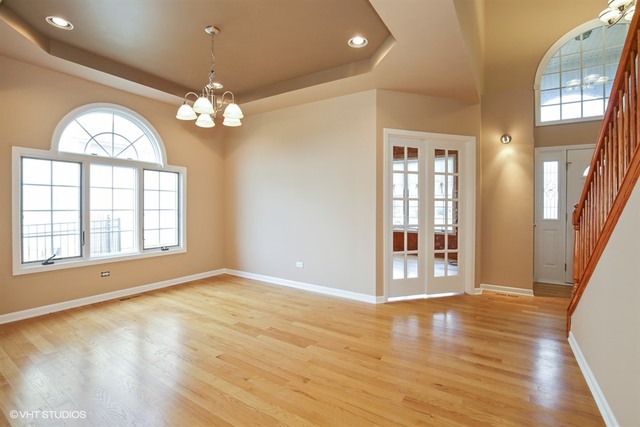 2309 Dean Street Sycamore, IL 60178 - Photo 8 of 25 a view of an empty room with a window and wooden floor