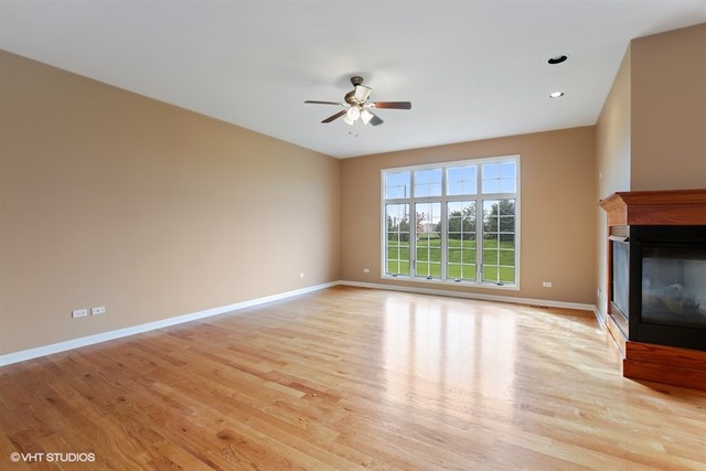 2309 Dean Street Sycamore, IL 60178 - Photo 9 of 25 a view of an empty room with a window and wooden floor