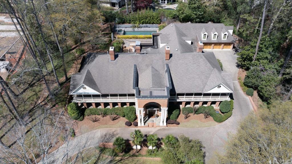 an aerial view of a house with yard swimming pool and outdoor seating