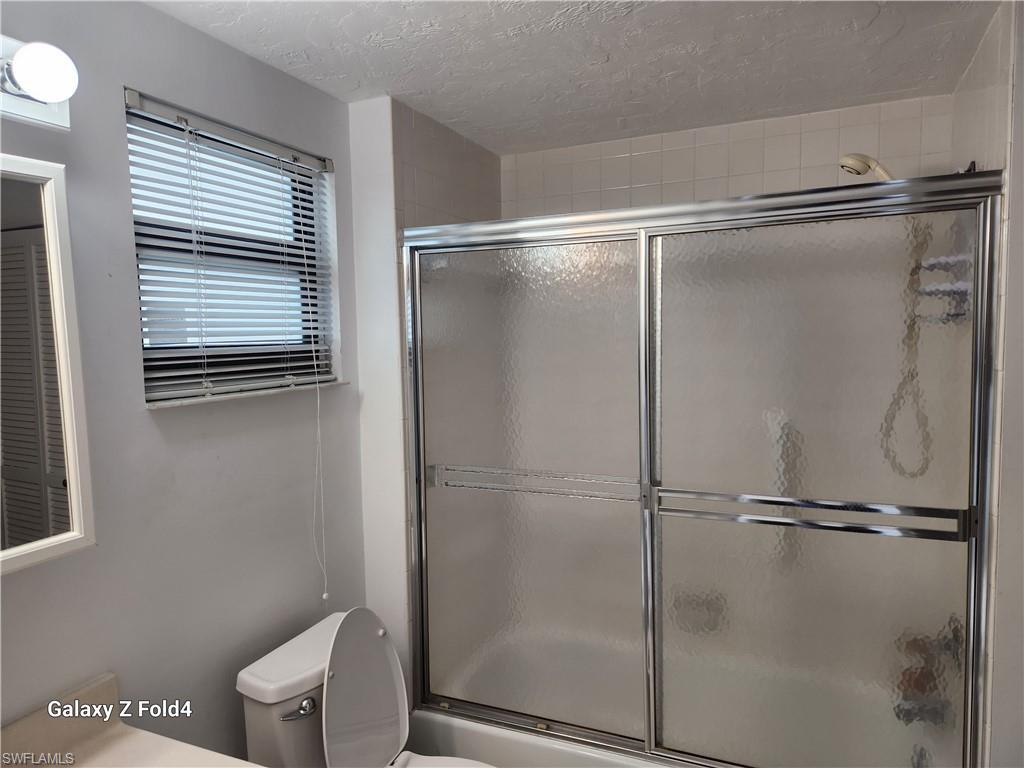 805 River Point Drive, Unit C307 Naples, FL 34102 - Photo 11 of 31 a bathroom with a shower and a toilet