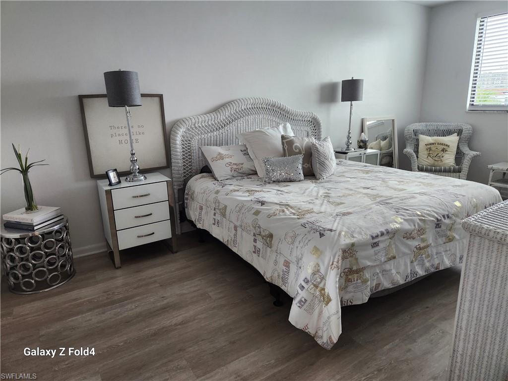805 River Point Drive, Unit C307 Naples, FL 34102 - Photo 12 of 31 a bed room with a bed and a night stand