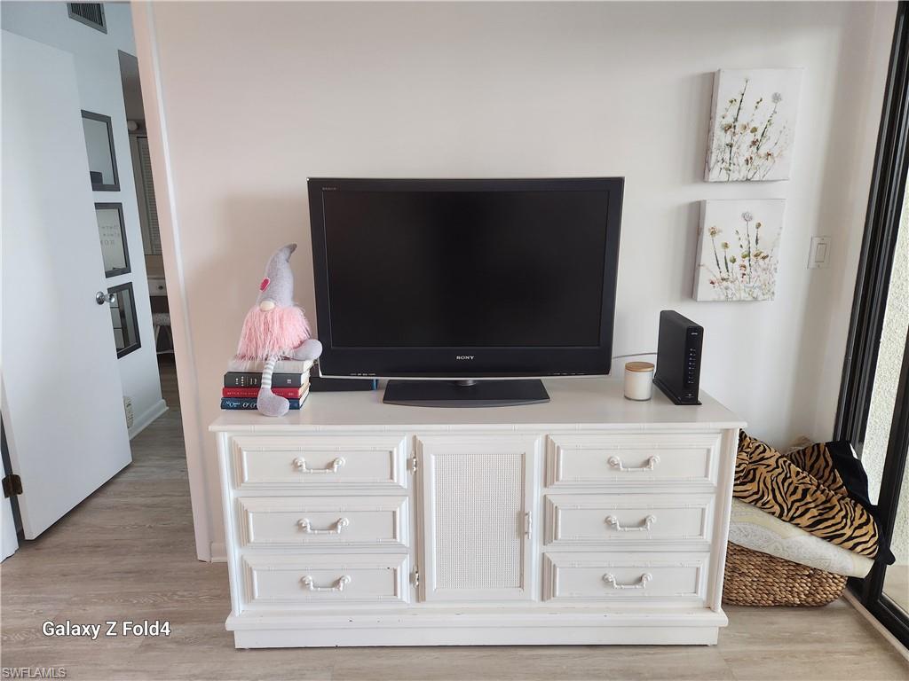 805 River Point Drive, Unit C307 Naples, FL 34102 - Photo 14 of 31 a living room with furniture and a flat screen tv
