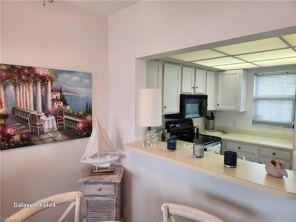 805 River Point Drive, Unit C307 Naples, FL 34102 - Photo 16 of 31 a kitchen with a sink cabinets and appliances