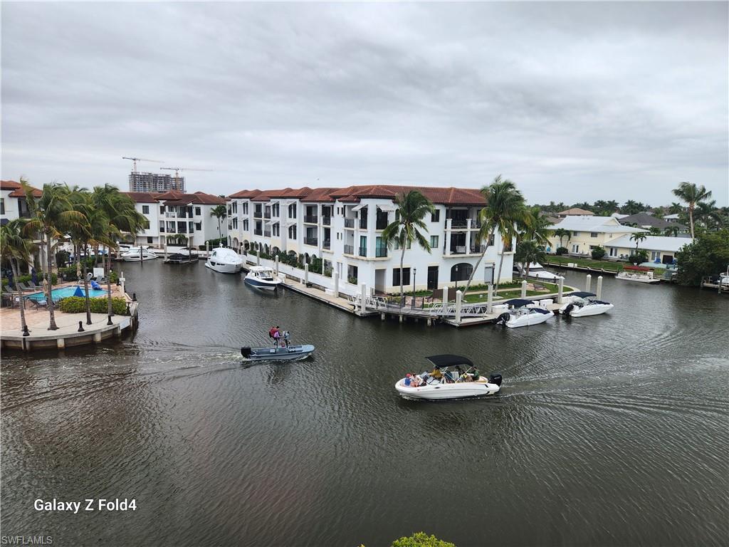805 River Point Drive, Unit C307 Naples, FL 34102 - Photo 20 of 31 a view of a lake with boats and trees
