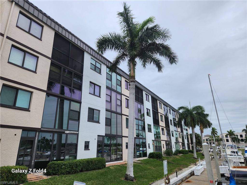 805 River Point Drive, Unit C307 Naples, FL 34102 - Photo 2 of 31 a front view of a multi story building with yard