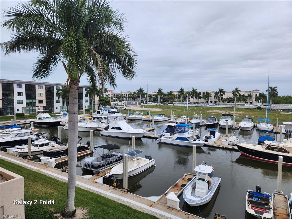 805 River Point Drive, Unit C307 Naples, FL 34102 - Photo 24 of 31 a view of a lake with a table and chairs