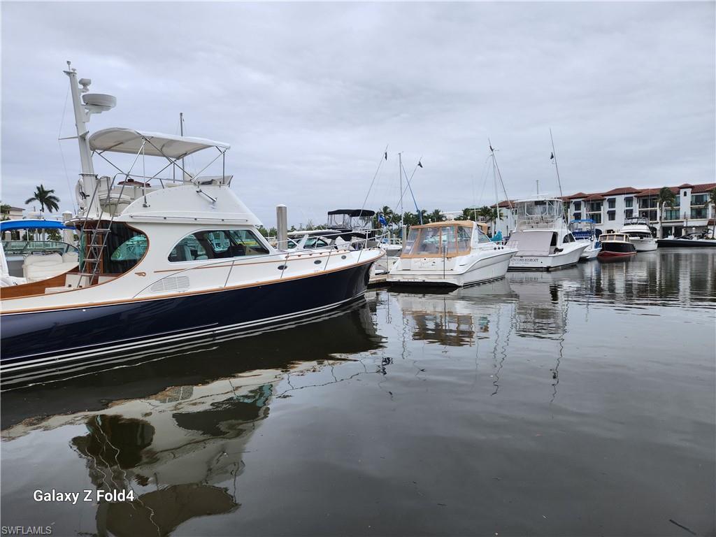 805 River Point Drive, Unit C307 Naples, FL 34102 - Photo 28 of 31 a dining room with a table and chairs