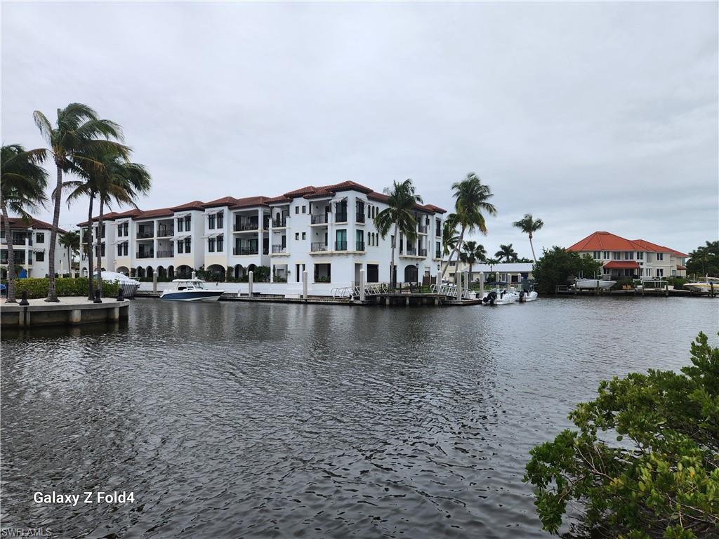 805 River Point Drive, Unit C307 Naples, FL 34102 - Photo 5 of 31 a view of a lake with houses