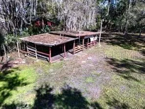 a view of a house with backyard porch and sitting area