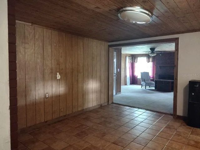 a view of a hallway with wooden shelves