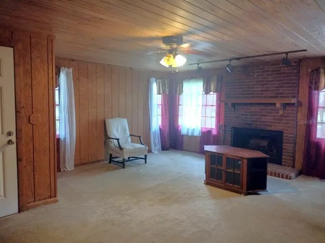 a living room with furniture a fireplace and a chandelier