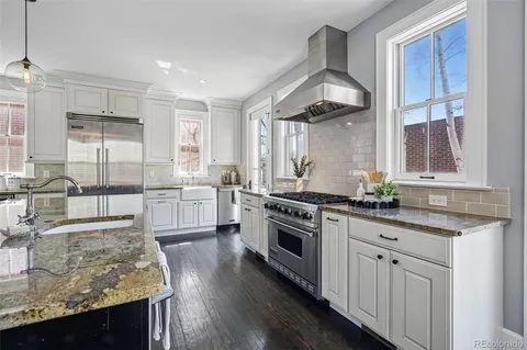 a spacious bedroom with a bed and a fireplace