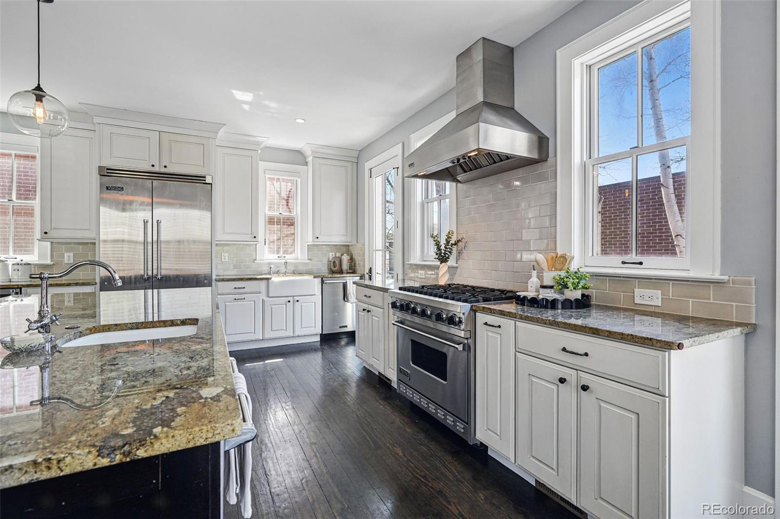 201 South Lafayette Street Denver, CO 80209 - Photo 19 of 48 a kitchen with stainless steel appliances granite countertop a sink stove and refrigerator