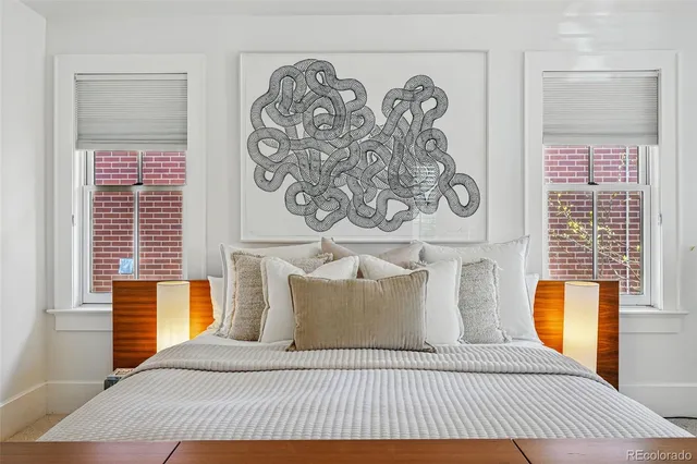 a bedroom with a large bed and a television