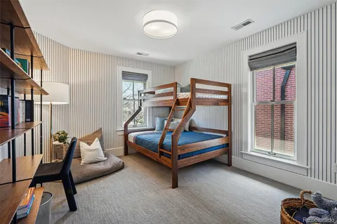 a bedroom with furniture and a book shelf