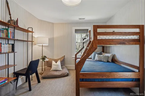 a bedroom with furniture and a window