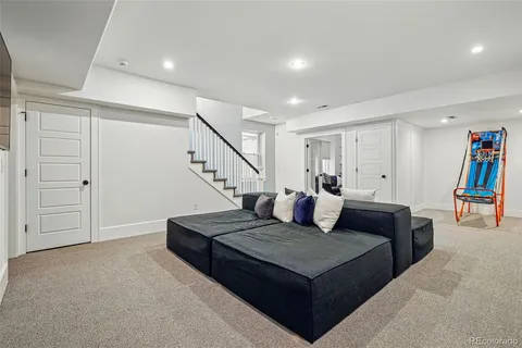 a living room with furniture and a book shelf