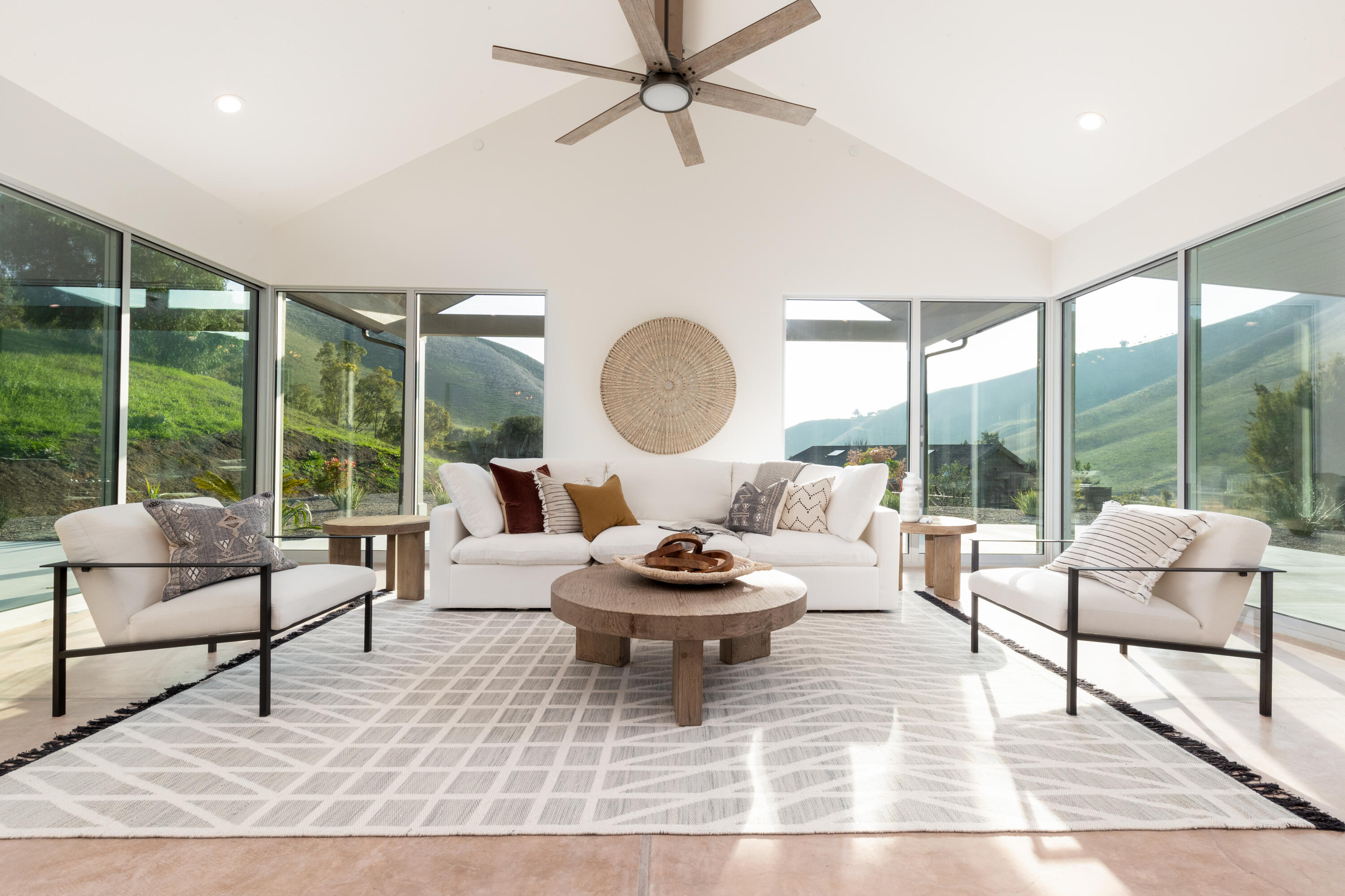 a living room with furniture and a floor to ceiling window
