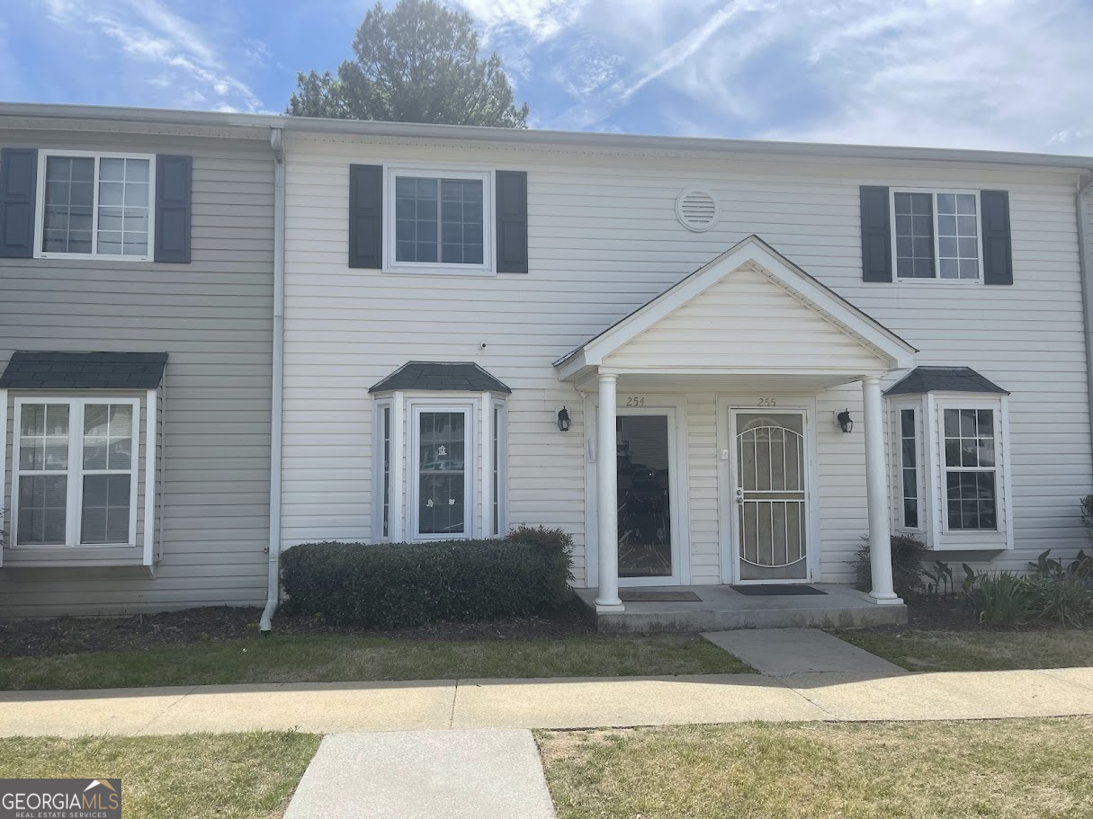 1625 Conley Road, Unit 254 Conley, GA 30288 - Photo 1 of 10 a front view of a house with garden