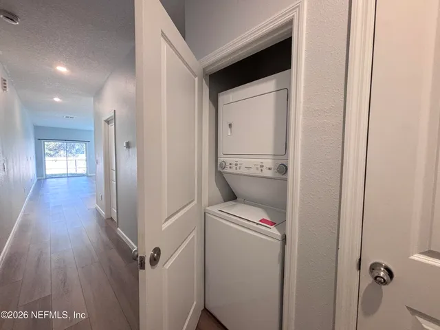 a large kitchen with cabinets wooden floor and stainless steel appliances
