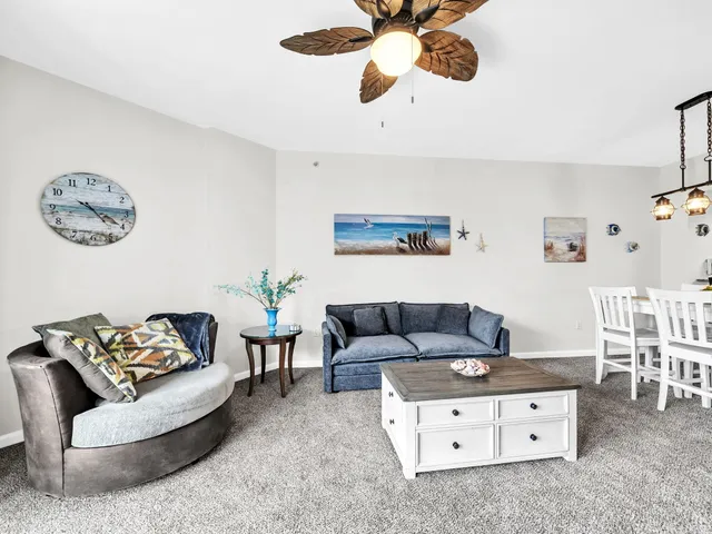 a living room with furniture and a dining area