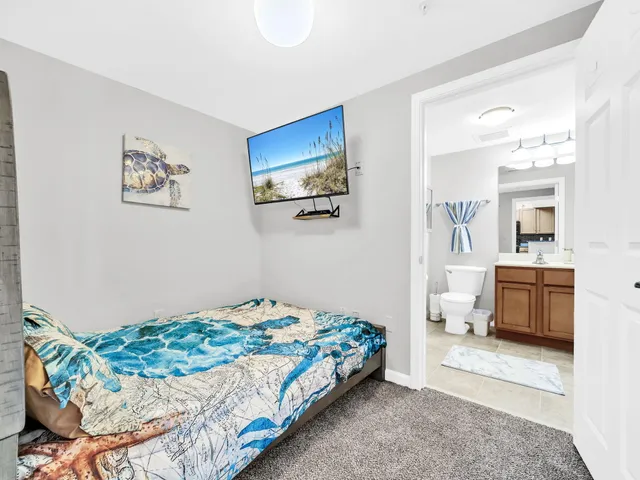 a bedroom with a bed and a view of kitchen