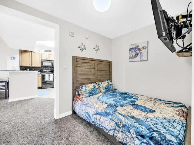 a bedroom with a bed and a flat screen tv