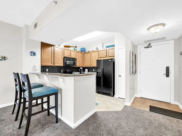 a kitchen with stainless steel appliances a refrigerator and a stove top oven