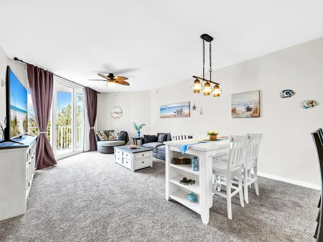 a living room with furniture a flat screen tv and a window
