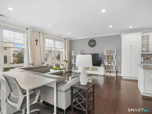 a living room with furniture and a large window