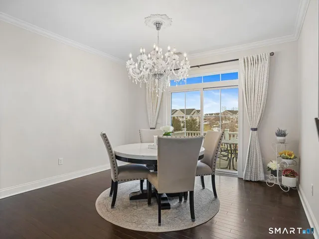 a view of a dining room with furniture wooden floor and chandelier