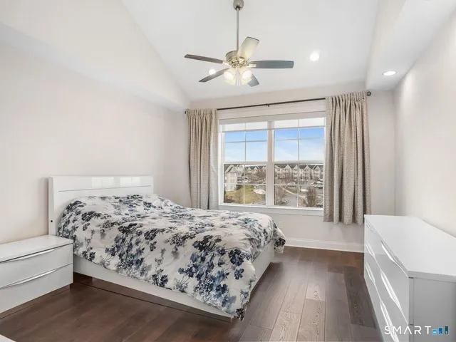 a bedroom with a large bed and a window