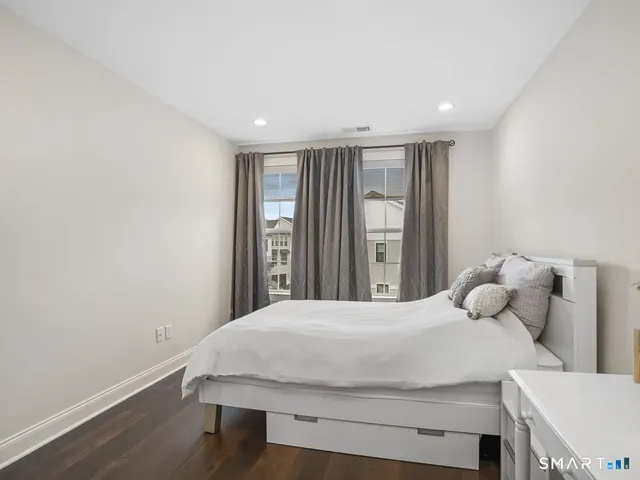 a bedroom with a bed and window