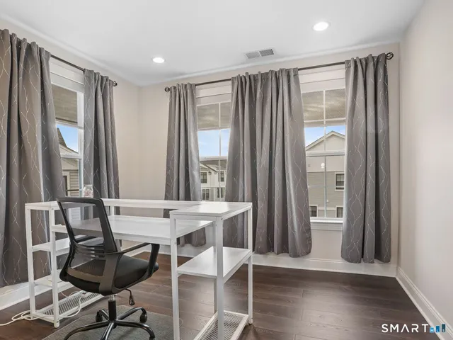 a dining room with furniture and wooden floor