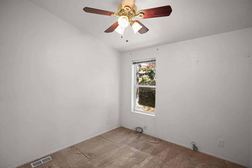 1281 Pleasant Valley Road, Unit 44 Diamond Springs, CA 95619 - Photo 20 of 27 an empty room with a window and a fan